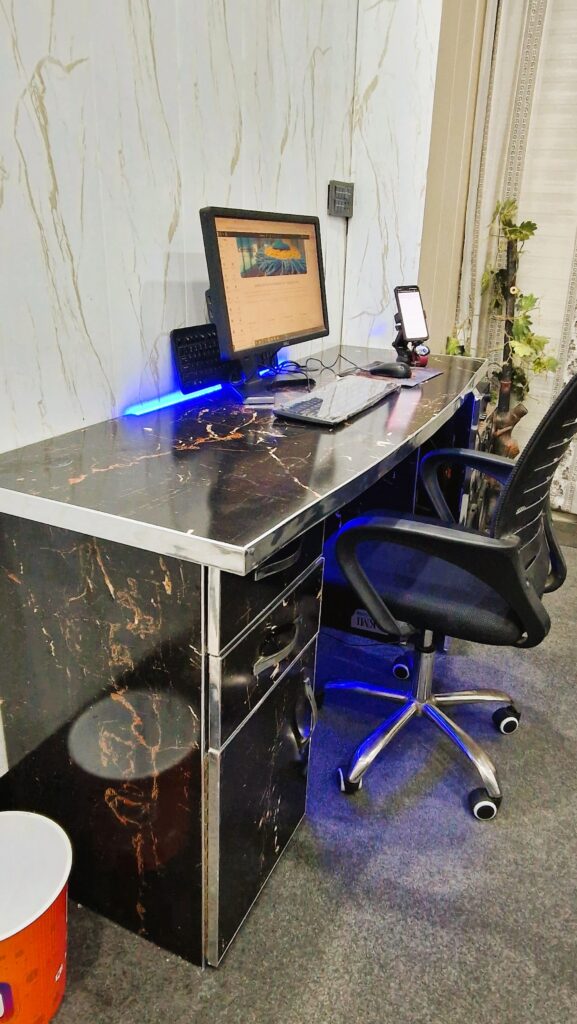 Zain Nasir working from his bed with a laptop, now running a full-time agency from his own office.